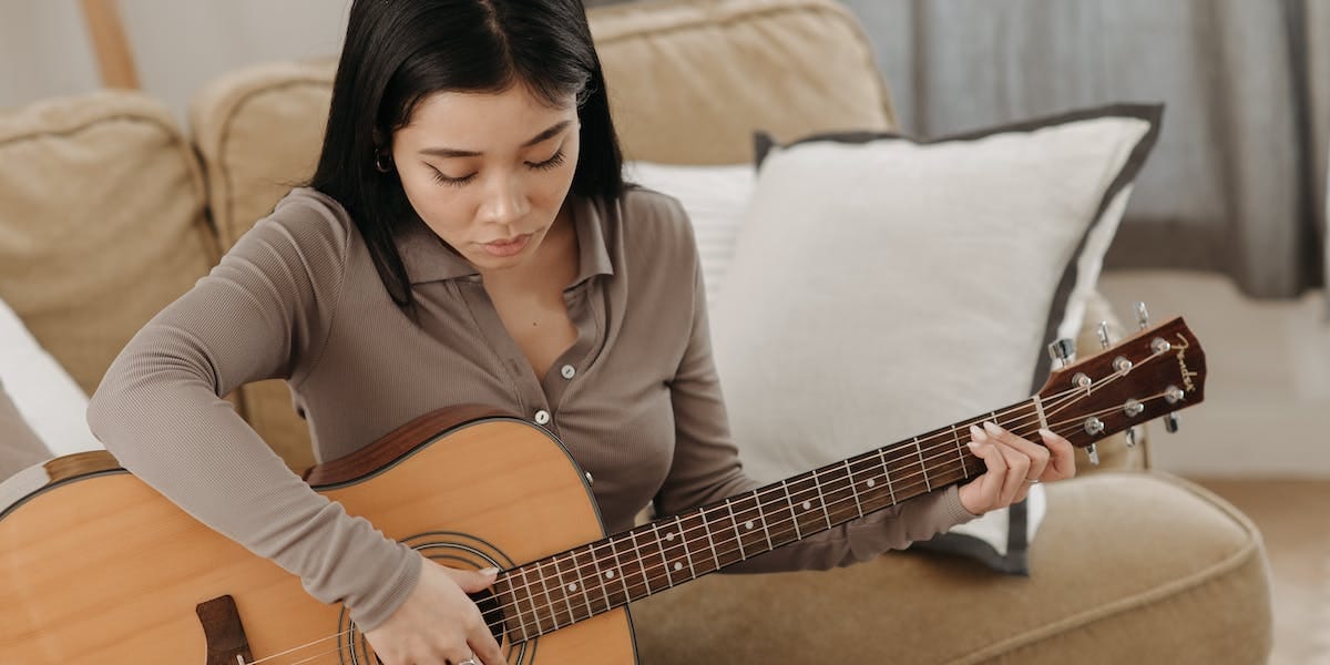 A beginner guitarist playing music