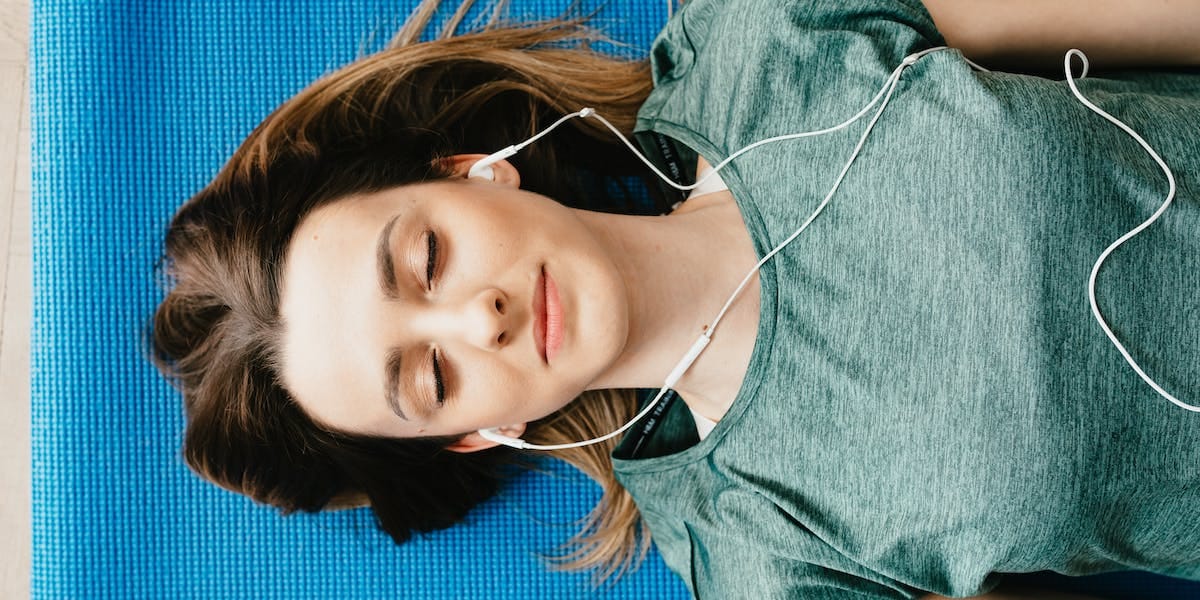 A girl meditating while listening to music