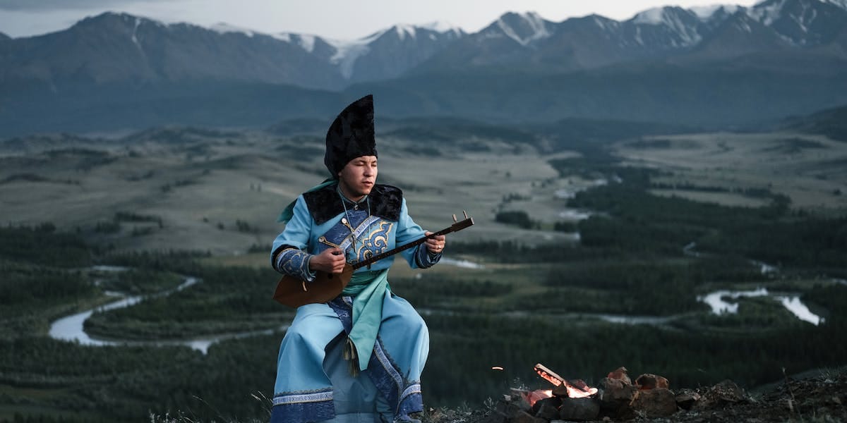 A man playing folk music