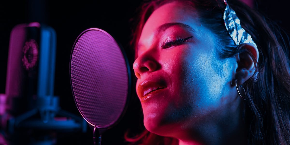A pop singer recording a song in the studio